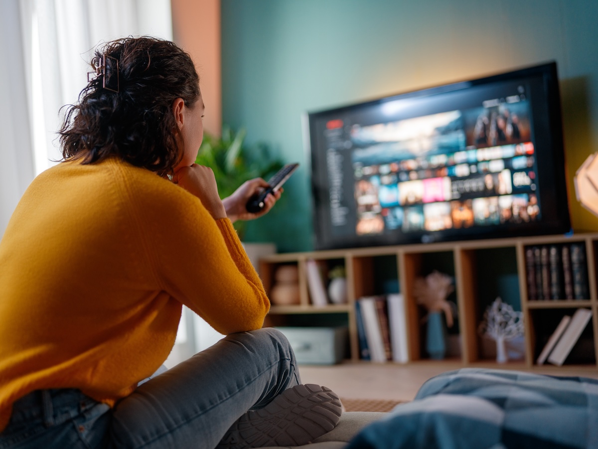 A photo of a woman scrolling through CTV.